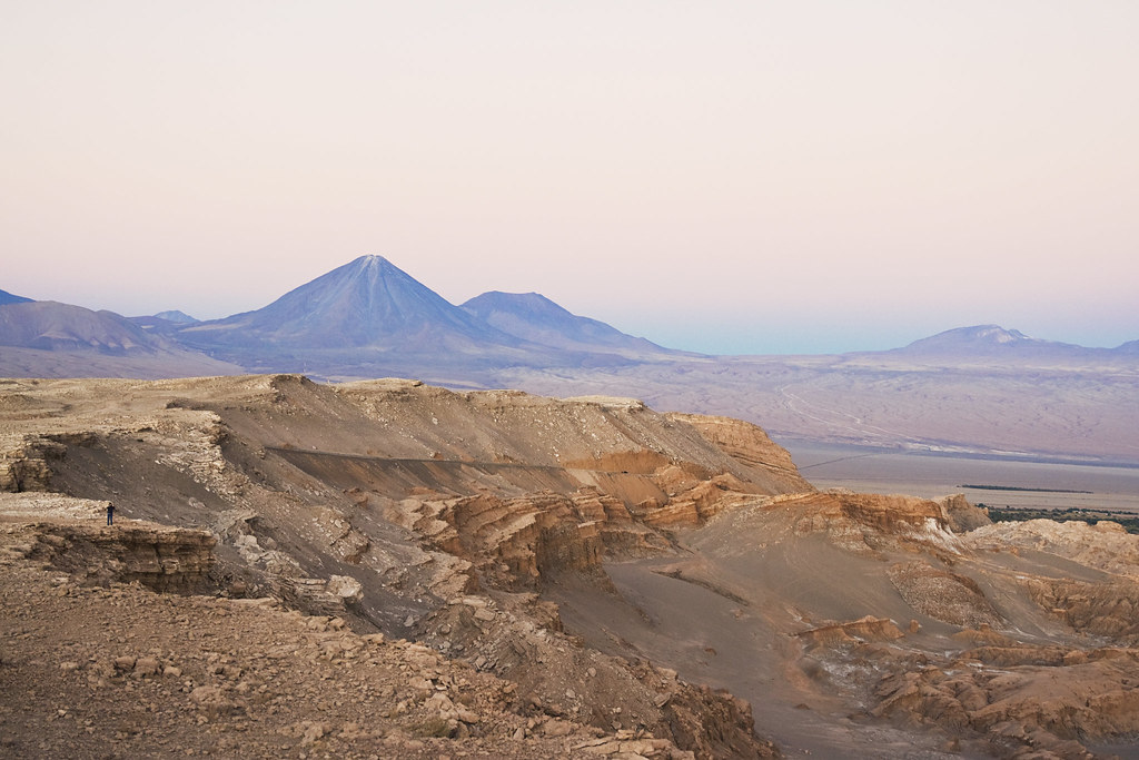 Arid terrain in Valle de la Muerte and Licancabur volcano at sunset in San Pedro de Atacama, Chile