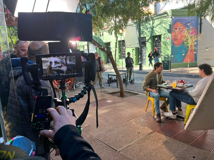Camera operator and crew coordinating an exterior production